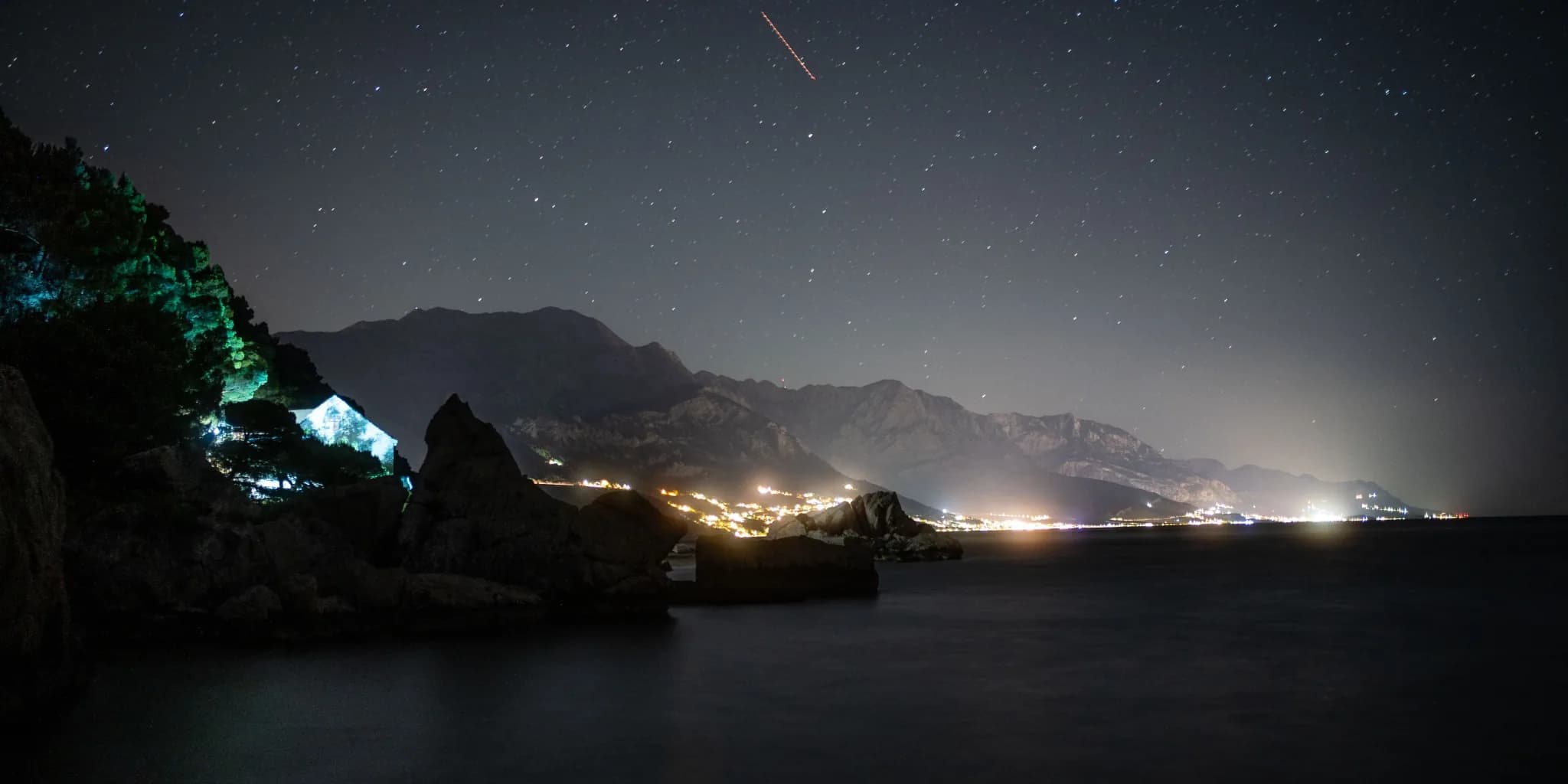 Starry night over a coastal mountain range