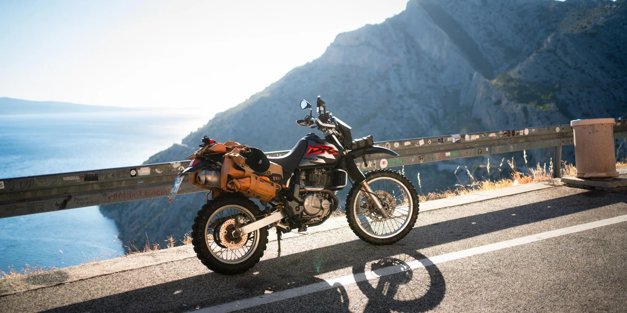 Motorcycle and rider in a mountain valley