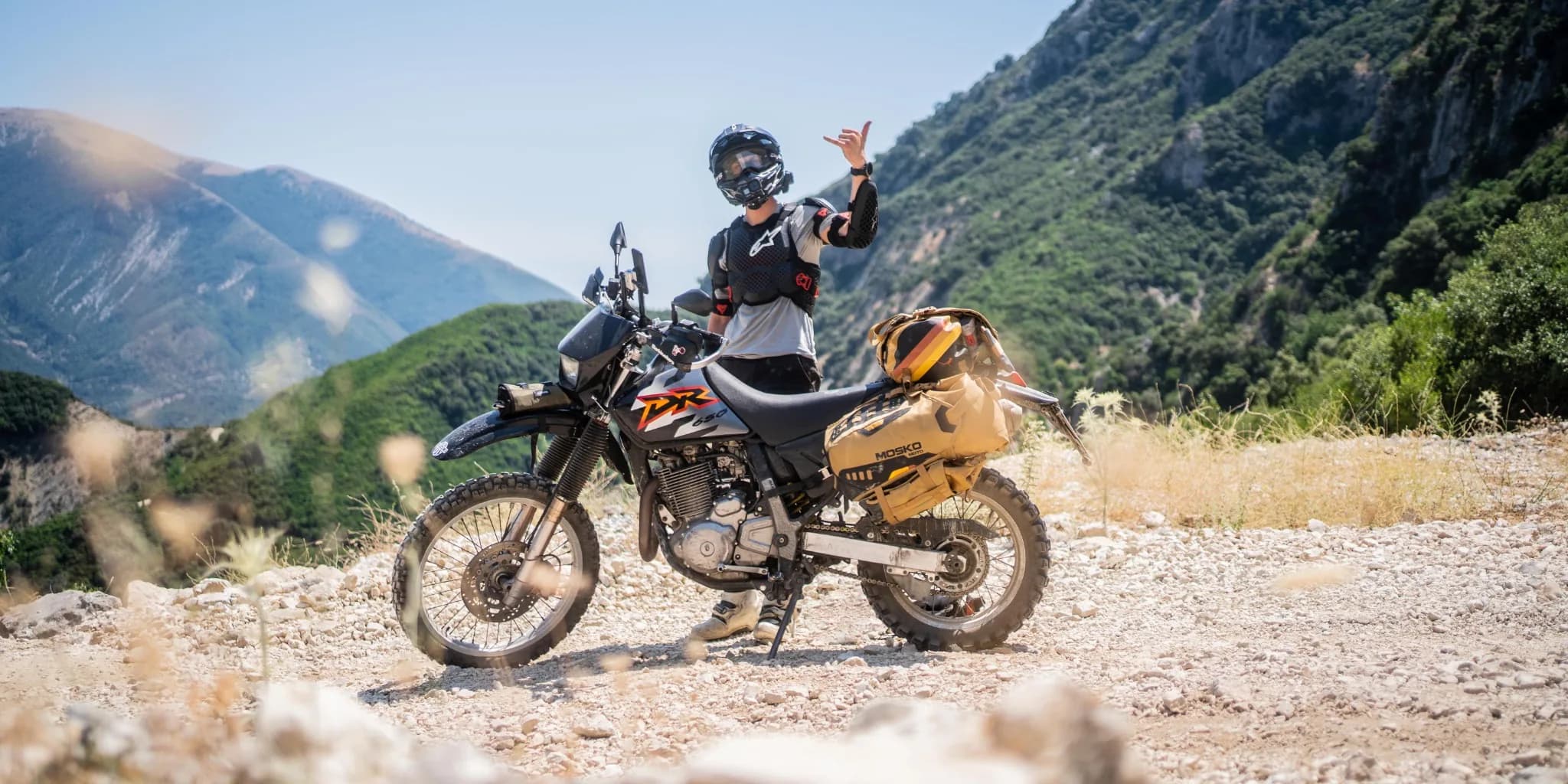 Motorcycle parked in the mountains at golden hour
