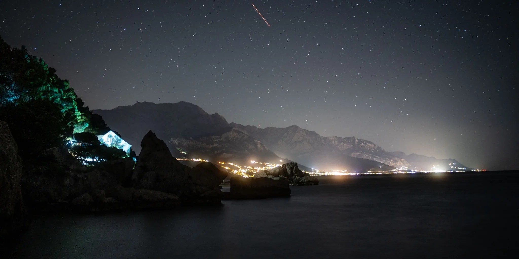 Starry night over a coastal mountain range